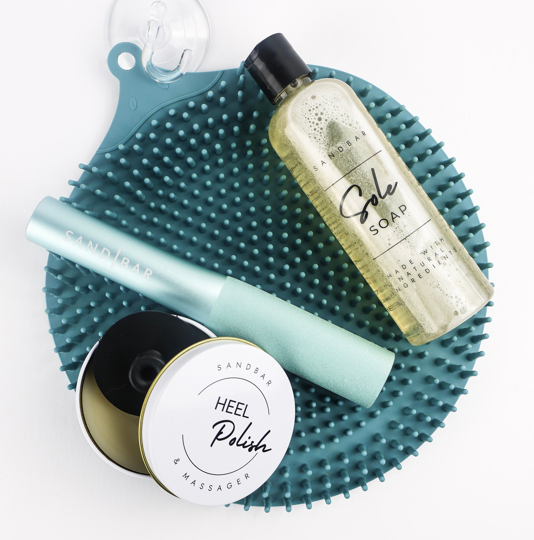 The Heel revival regimen, includes the Foot scrubber mat with shower hook, Sole Soap, Foot File, and Heel polish with applicator.