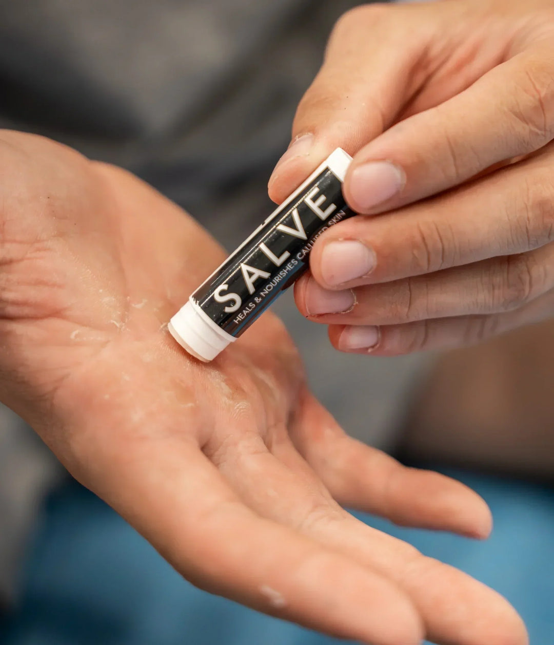 Person applies Sandbar Callus Care Salve directly to a callused palm. 