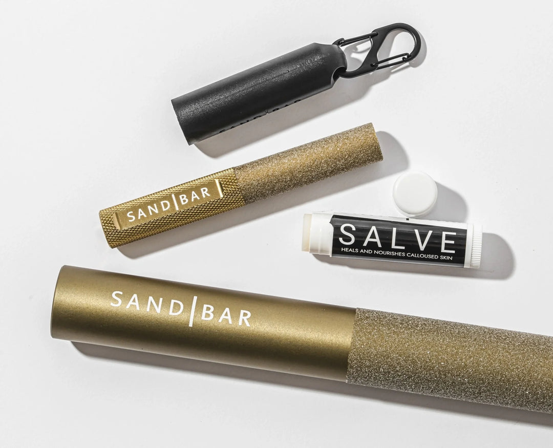 SandBar Callus Care callus tools and salve arranged on a clean white surface.