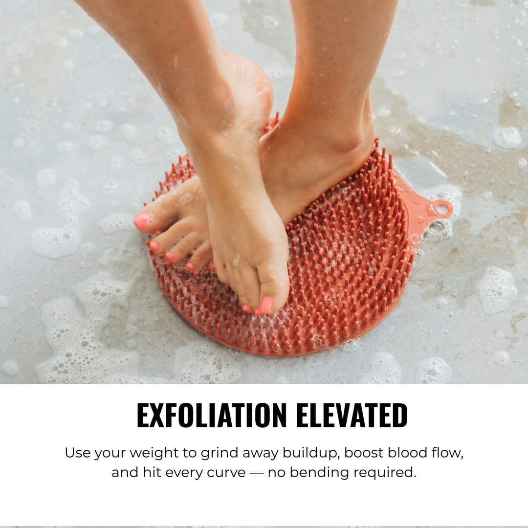 Person cleaning feet on silicone scrubber mat in shower for exfoliation and circulation support