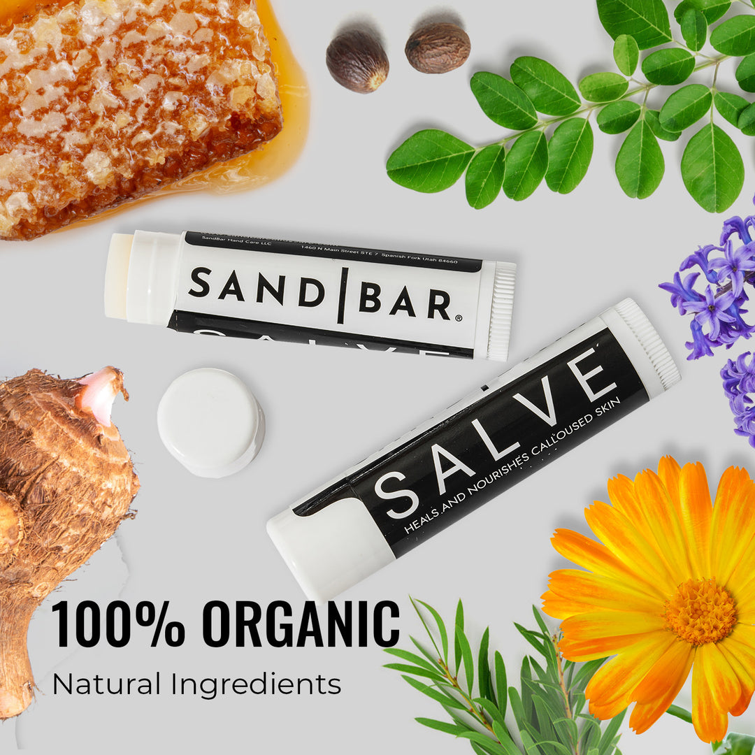 Tubes of SandBar Salve next to plant and organic ingredients.