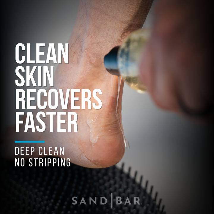 Applying Sole Soap onto heel over foot scrubber mat for deep cleaning