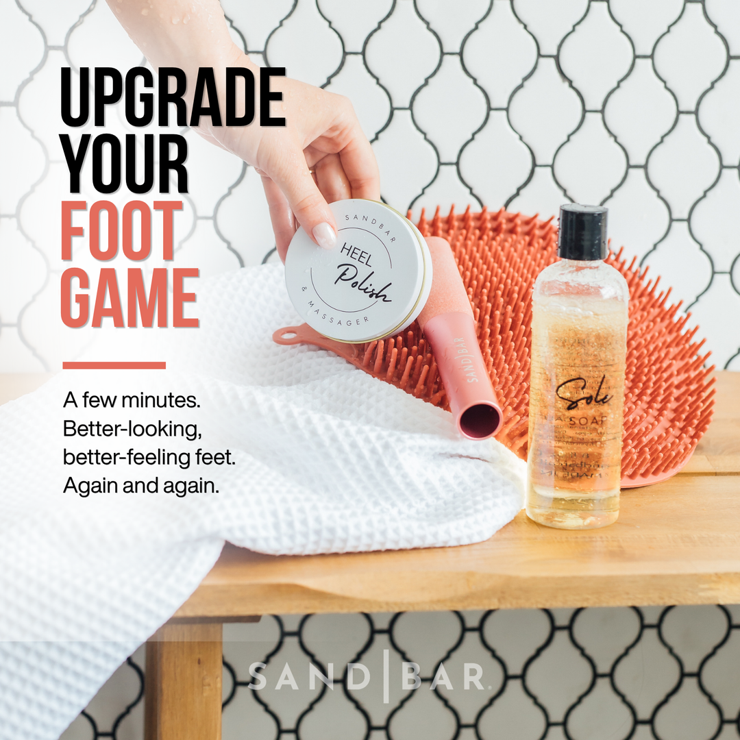 SandBar Heel Revival foot care kit with Heel Polish, Sole Soap, shower scrubber mat, and foot file displayed on a towel.