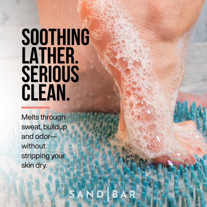 Sole Soap creating a rich soothing lather on a foot scrubber mat for deep foot cleansing